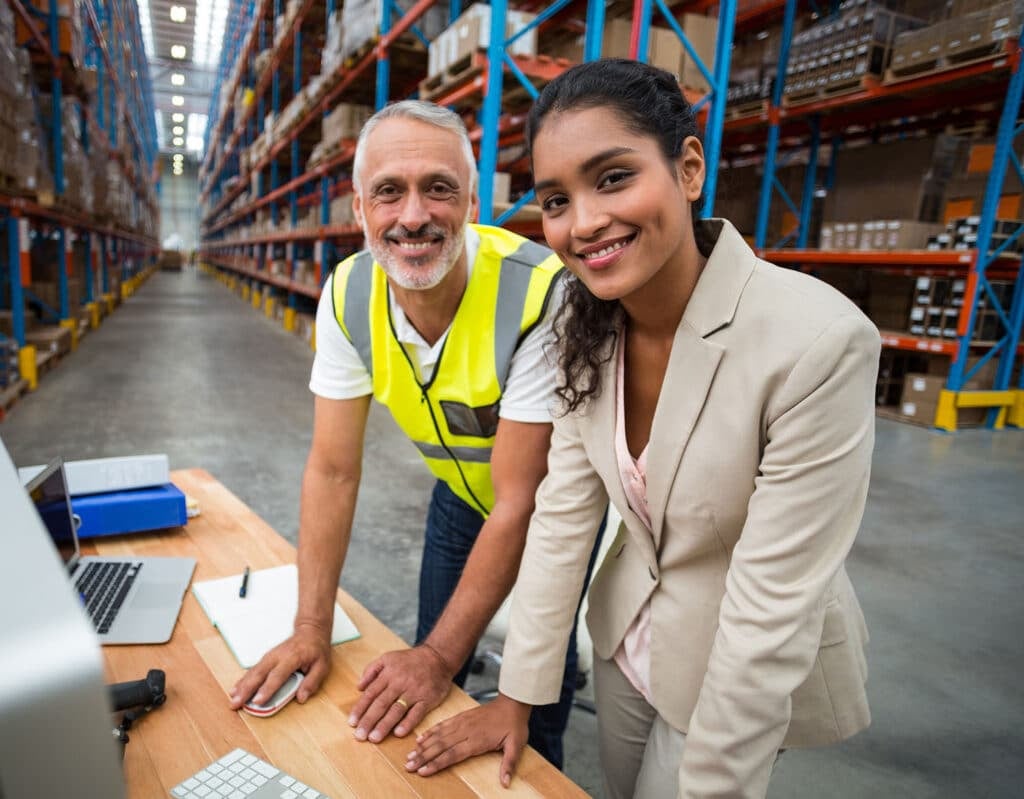 Portrait of warehouse manager and worker working together